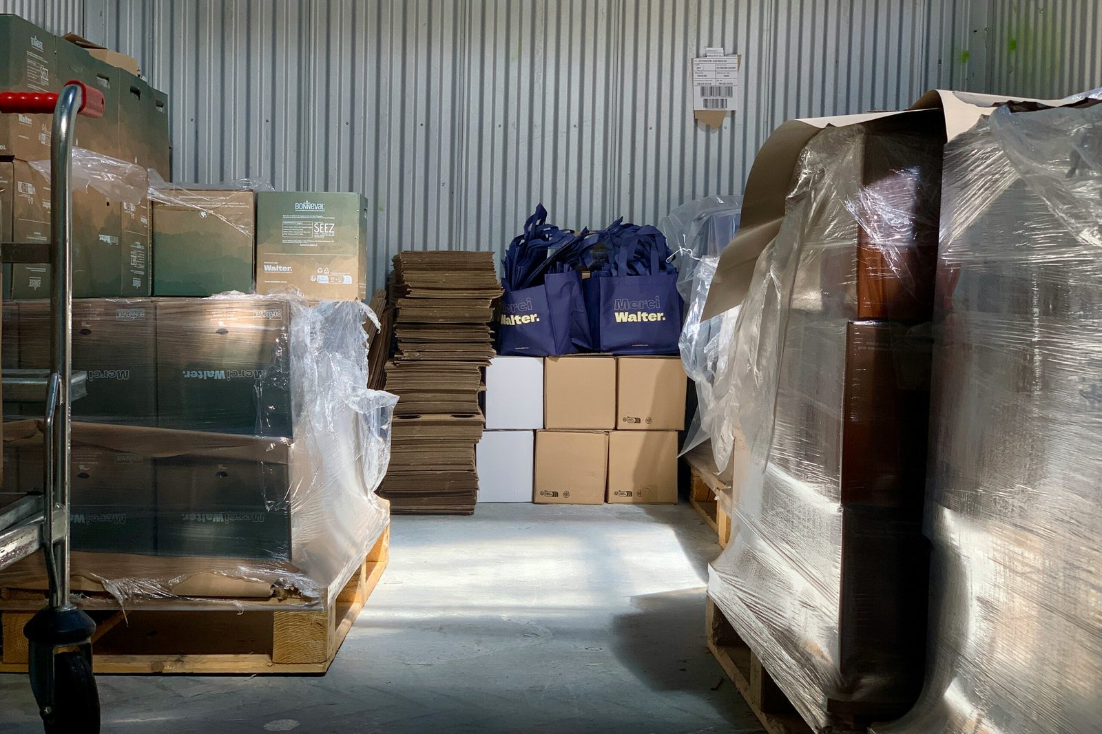 Unsplash image of a clean, organized warehouse with furniture boxes ready for shipping