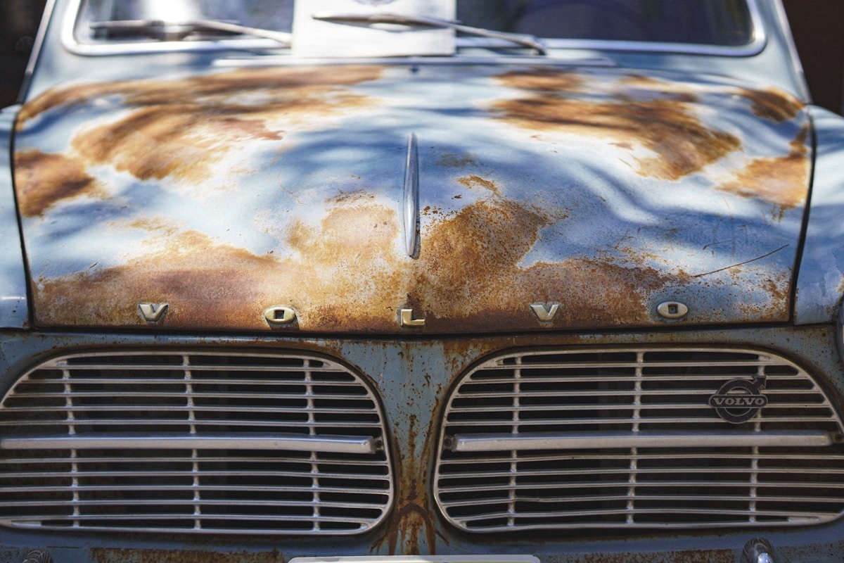 Rusty volvo car hood and grill close-up.