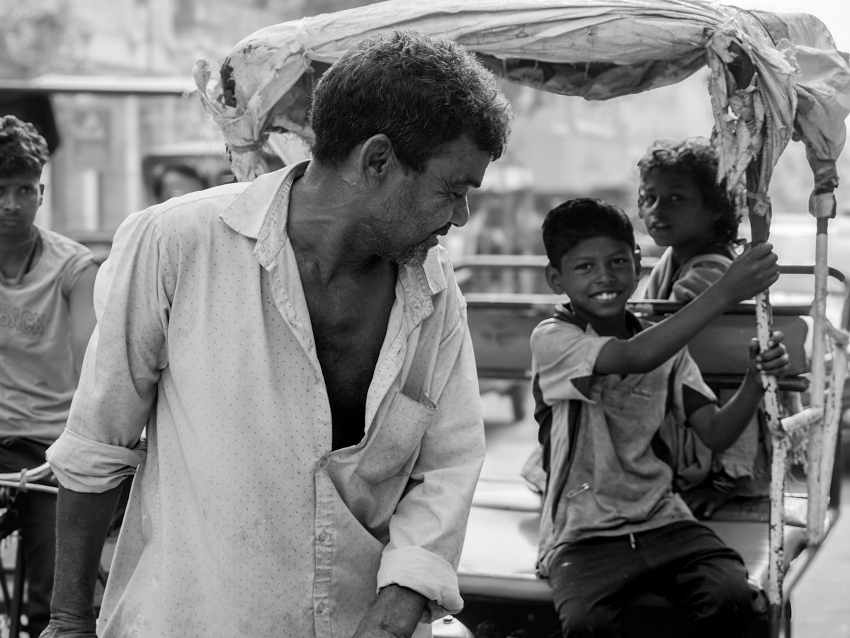 Man with children in a rickshaw