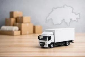 Miniature camion déménagement, cartons et carte Suisse symbolisent le meilleur transporteur meubles suisse.