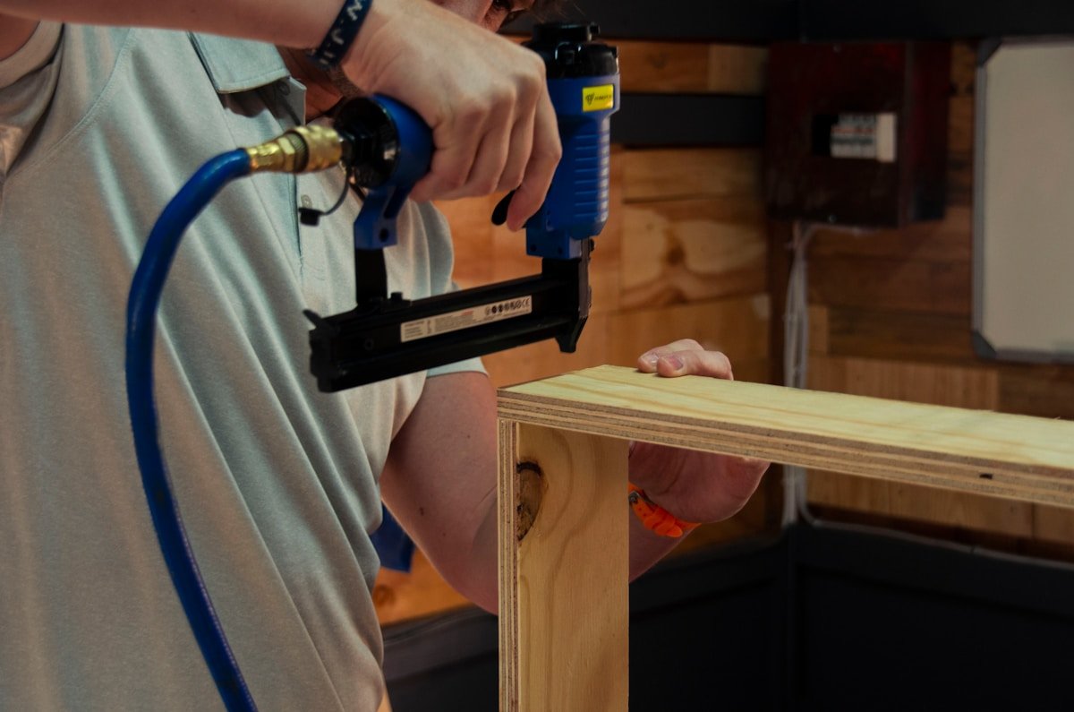 a man using a power drill on a piece of wood