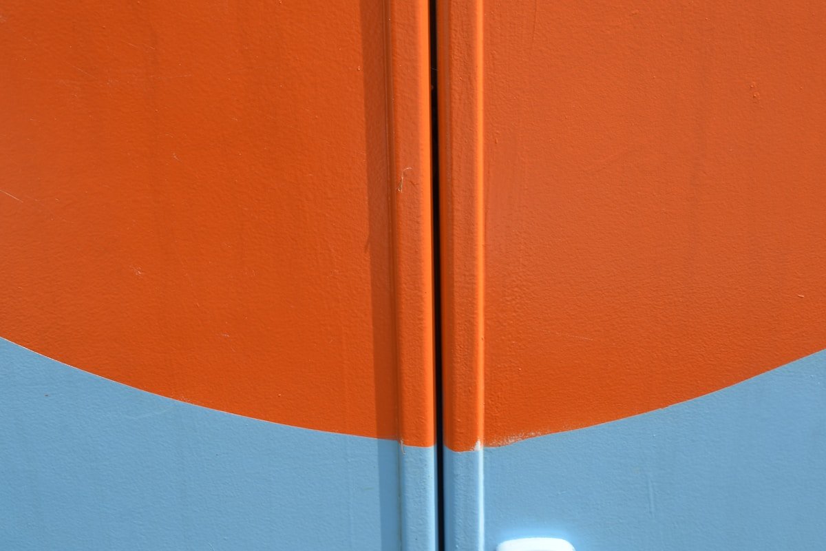 a close up of a blue and orange door