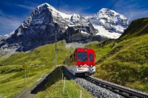 solution transport volumes importants suisse - red and white train on rail road near snow covered mountain during daytime